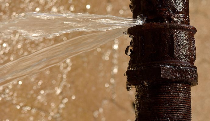Water leaking from a broken water pipe